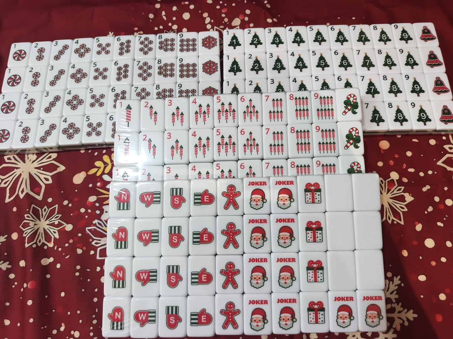 Christmas American Mahjong Set - full 160 tiles spread on red holiday background