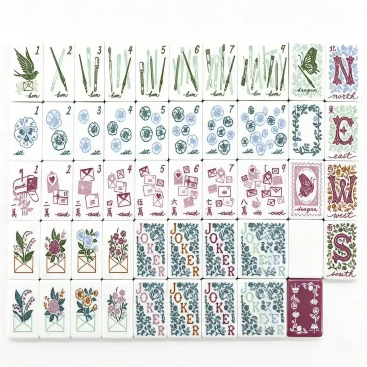 Floral Garden Mahjong Set - close up of tiles showing dot suit pansies, crack envelope, bam brushes, butterfly dragon and burgundy back tiles
